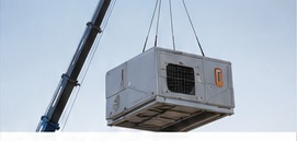 Rooftop HVAC unit being lifted by crane for a Los Angeles installation